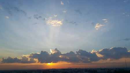 Strong morning sun light sine through the grey cloudの写真素材