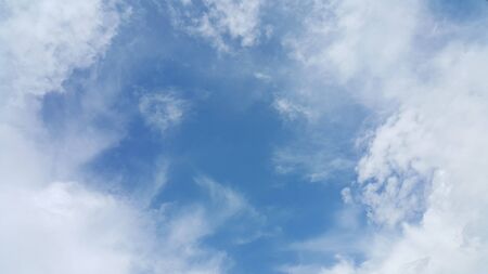 Blue sky and fluffy cloudの写真素材