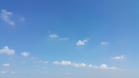 Blue sky with a line-shape cloud.の写真素材