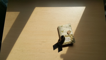 Black bow stack on the card holder under the sun shine.の写真素材