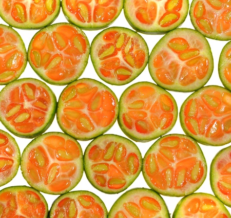 close up of slices of little gourd arranged on white 