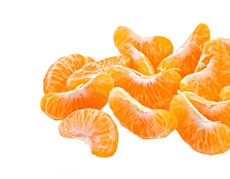 pieces of peeled orange on white の写真素材