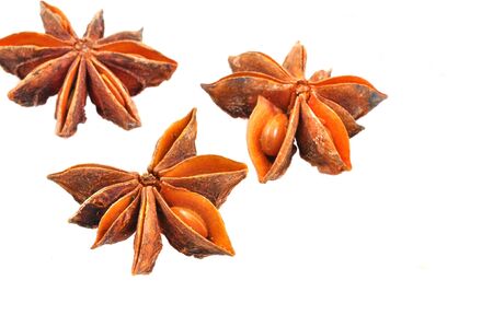 close up of star anise spice arranged on white background
