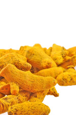 close up of whole turmeric arranged on white の写真素材