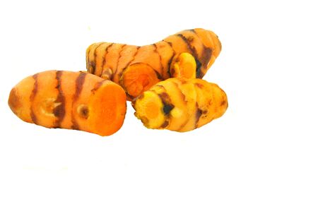 close up of fresh roots of  turmeric arranged on white 