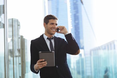 Businessman using a mobile phone and a digital tabletの写真素材