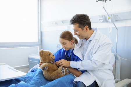 Doctor checking girl in hospitalの写真素材