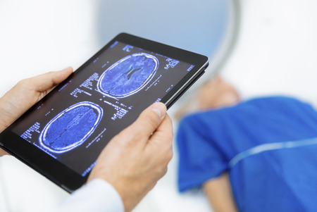 Doctor examining X-Ray scanner the forehead