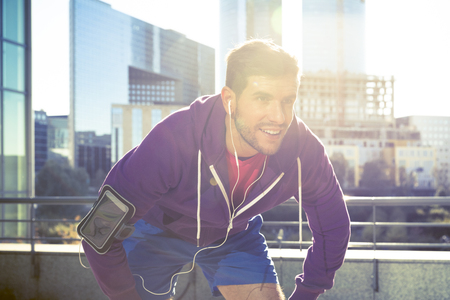 athlete with earphones running in the cityの写真素材
