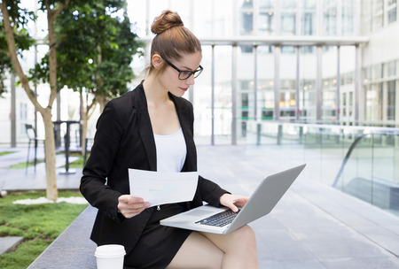 Businesswoman working on laptop in officeの写真素材