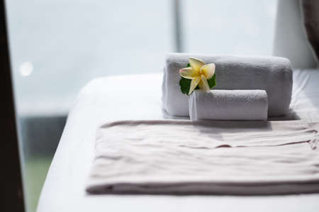 White towel  and some flowers on the bed in Honey moon suit