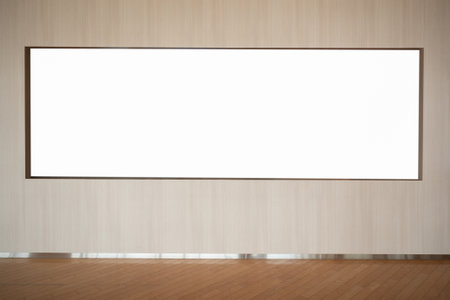 Blank billboard on wall in room with wooden floor and white wallの写真素材