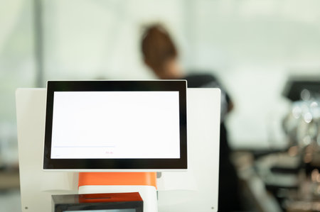 Blank screen computer monitor in coffee shop blur background with bokeh.