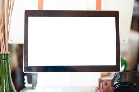 Mockup blank screen computer on table in coffee shop, stock photoの写真素材