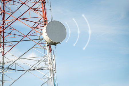 Telecommunication tower with satellite dish on blue sky background,communication conceptの写真素材
