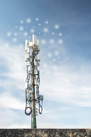 Telecommunication tower against blue sky with white clouds. Communication and technology concept