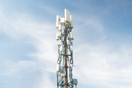 Telecommunication tower with blue sky background. Communication and technology concept.