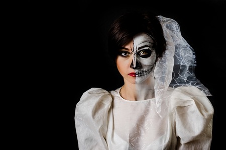 Young woman in day of the dead mask skull face art.の写真素材