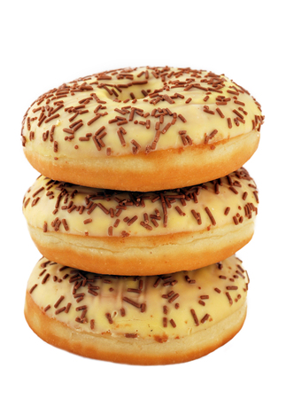 Tower of chocolate donuts isolated on white backgroundの写真素材