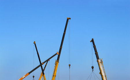 Truck crane boom on blue sky background