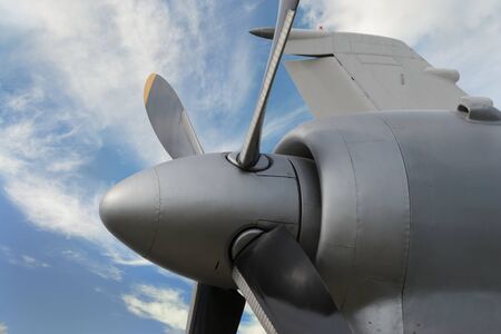Close up of airplane turboprop engine with propeller on cloudy sky background の写真素材