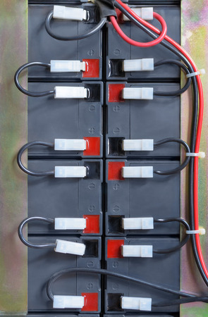 Industrial battery block hooked up with red and black cablesの写真素材