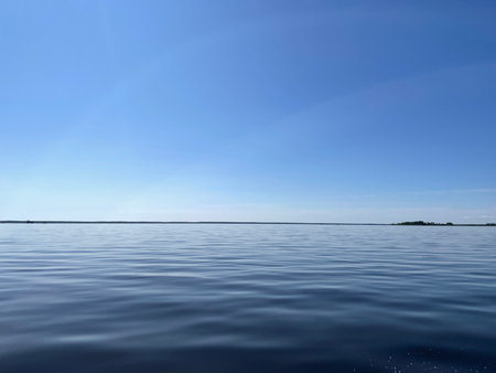 blue sky and calm water surface of lake, natural background, nature seriesの写真素材