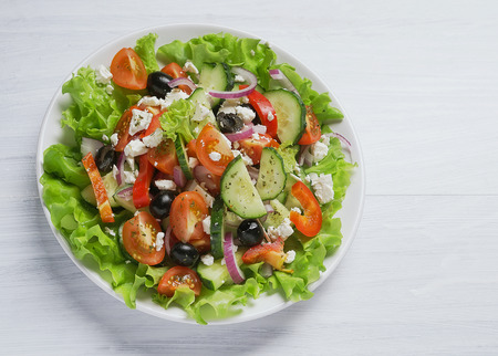 Fresh vegetable Greek salad, white background, top viewの写真素材