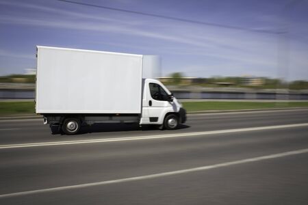 White Delivery Van Speeding on Highwayの写真素材