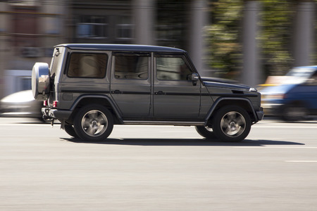 Gray car fast drive on asphalt road at daytimeの写真素材