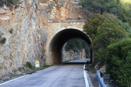 Stone tunnel at mountain roadの写真素材