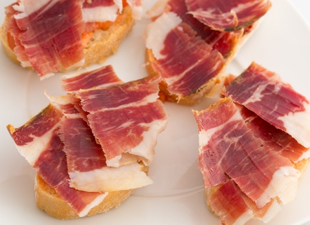 Spanish tapas, ham and tomatoの写真素材