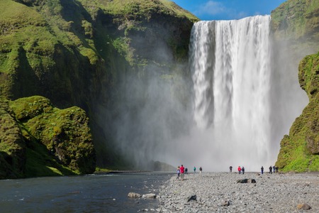 skogafoss waterfall and tourists (blurred faces) on the South of Iceland near the town Skogarのeditorial素材