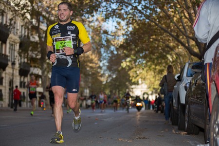 VALENCIA - NOVEMBER 17: Ruben Ruiz Crespo (number 412) runner participates in Valencias marathon on...