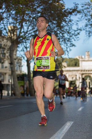 VALENCIA - NOVEMBER 17: Abel Homs Valldeoriola (number 1140) runner participates in Valencias marathon on November 17, 2013 in Valencia, Spainのeditorial素材