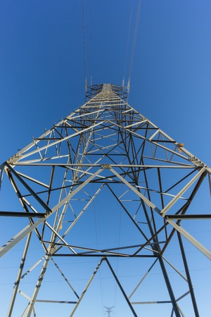 Entire electric tower ultra wide angle view over blue skyの写真素材