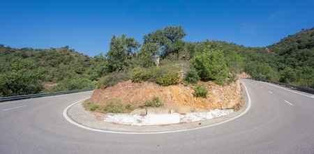 Ultra wide angle view of mountain hairpin bend curved roadの写真素材