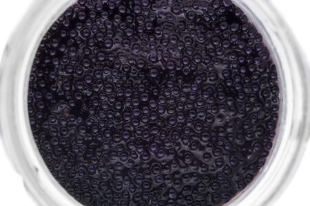 Black caviar in small round jar, top view