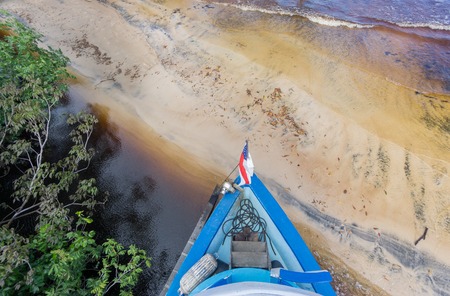 Boat arrives to sand beach