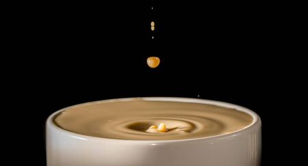 Serving coffee fast motion, side view of cupの写真素材