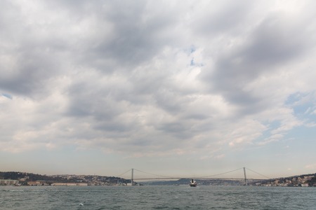 Bosphorus with buildings and suspension bridge in Istanbulの写真素材