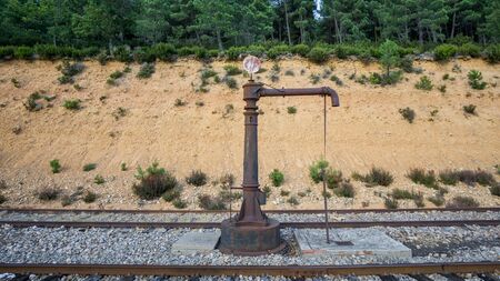 Detailed view of vintage railroad water pump near railwayの写真素材