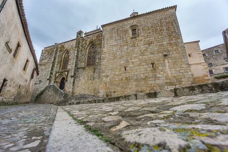 Cloudy day in Trujillo with paved street and stone buildings, Spainの写真素材