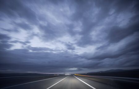 Wide angle view of car driving during night, blurred motionの写真素材