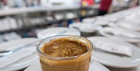 Wide angle of bar with a cup coffee in the foreground