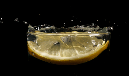 Water drops, glass of water, slice of with lemonの写真素材