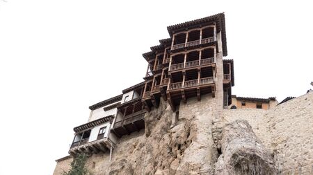 Wide angle view of hanging houses against white sky in Cuenca, Spain