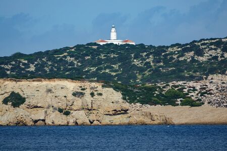 Long shot of lighthouse over islandの写真素材