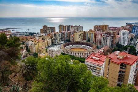 Wide angle view of Malaga city and bullfight arena near mediterranean seaの写真素材