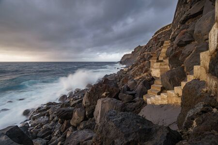 Terceira island coastline with stairs and waves breaking, long exposureの写真素材